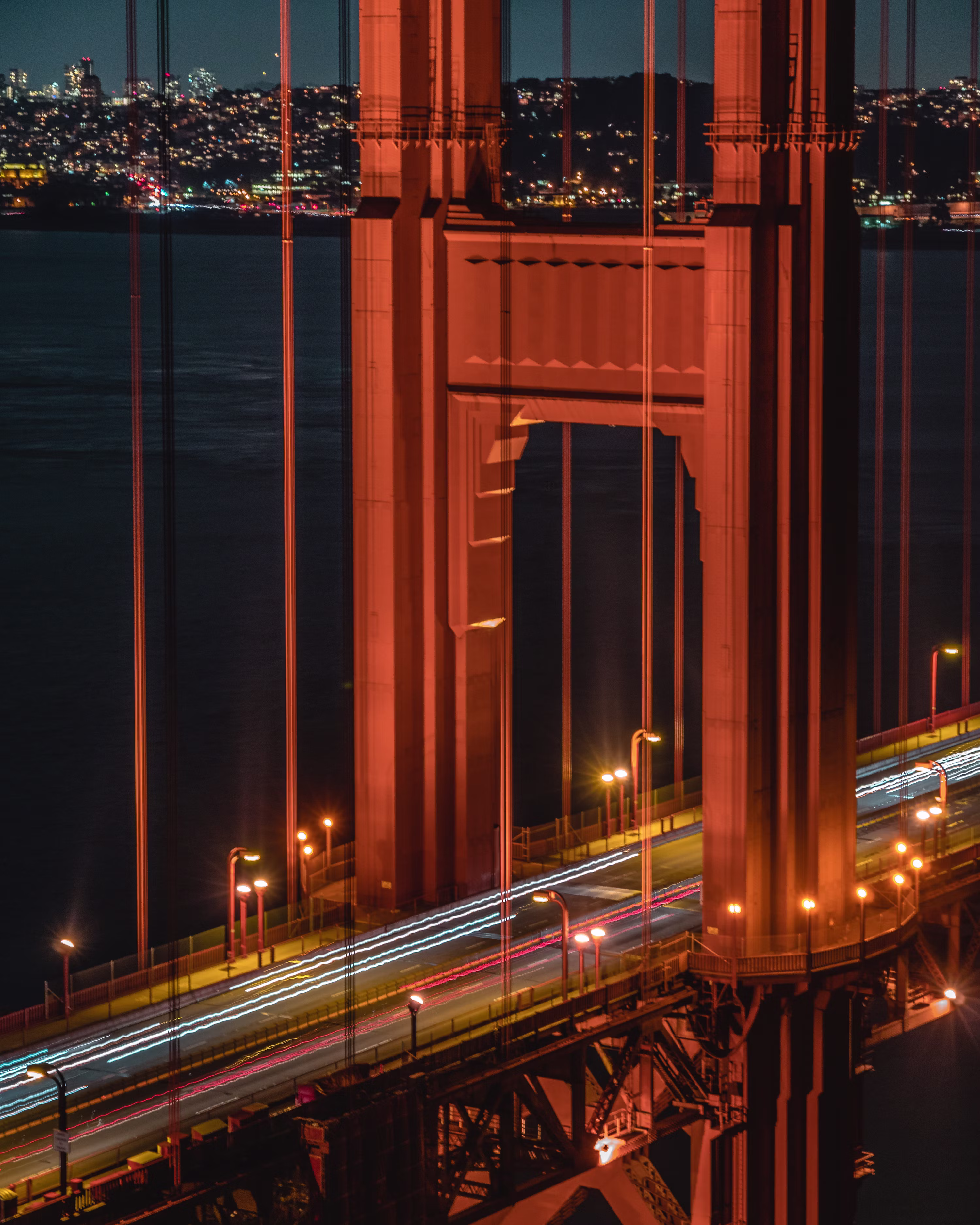 The Golden Gate Bridge tower lit at night